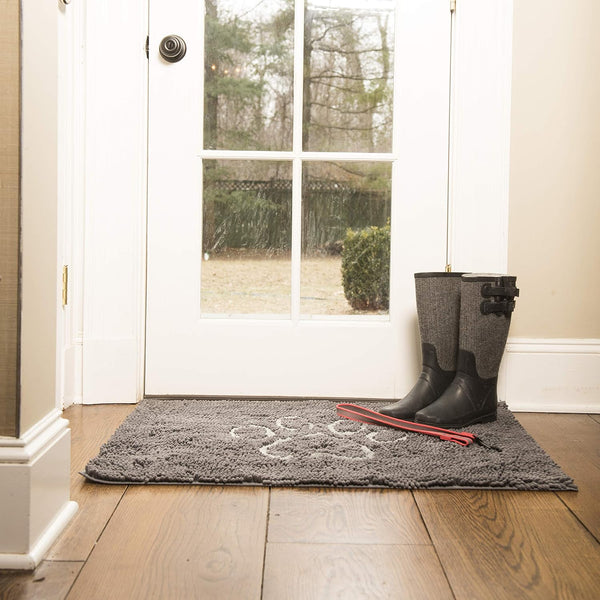 A high-quality image of the Dirty Dog Door Mat placed at the front door, showcasing its ability to trap dirt and water from entering the home.