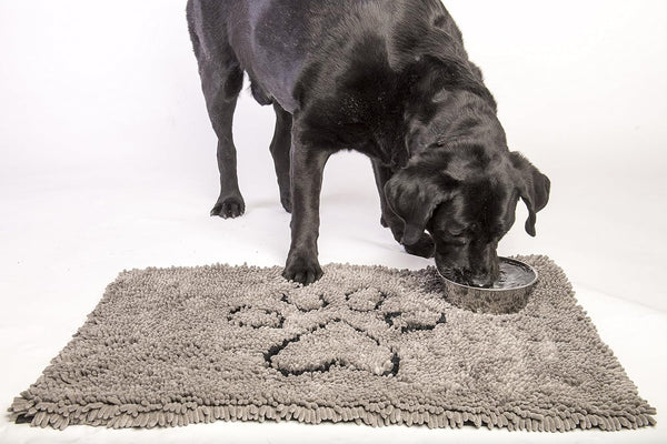An image showing a water dish placed on the Dirty Dog Door Mat, demonstrating its absorbent quality to contain spills.