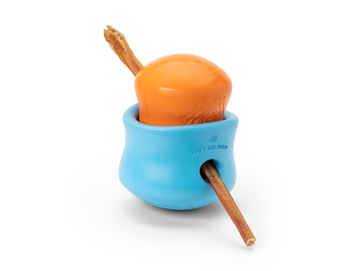 Image of a small West Paw Toppl toy placed inside a large Toppl, with a bully stick inserted through both, demonstrating a creative way to use the toy.