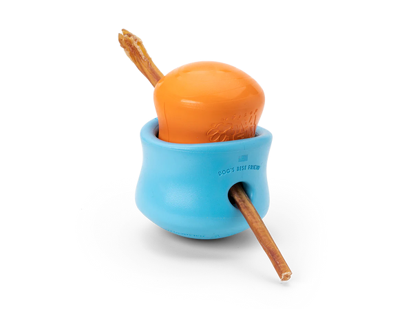 Image of a small West Paw Toppl toy placed inside a large Toppl, with a bully stick inserted through both, demonstrating a creative way to use the toy.