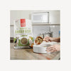 A pet owner scooping out The Honest Kitchen Whole Food Clusters - Grain Free Chicken, ready for serving.
