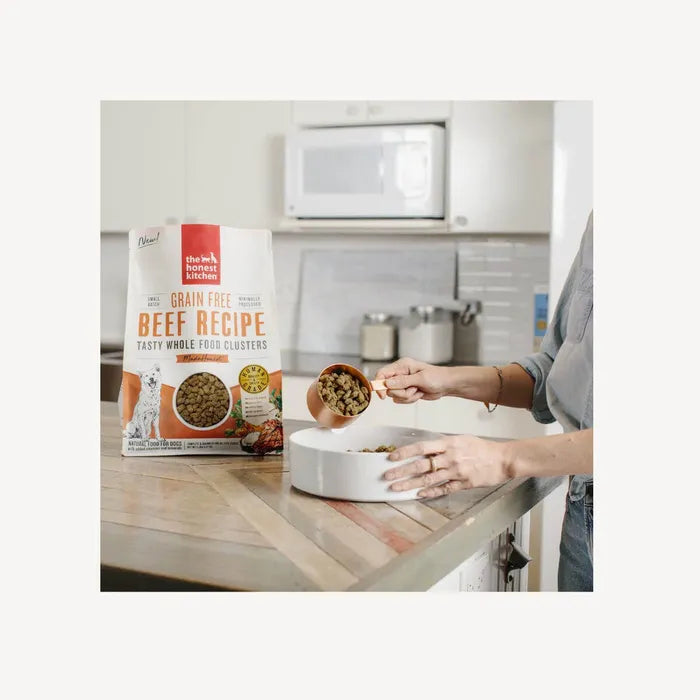 Dog owner scooping out The Honest Kitchen Whole Food Clusters - Grain Free Beef, ready to serve.