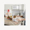 Dog owner scooping out The Honest Kitchen Whole Food Clusters - Grain Free Beef, ready to serve.