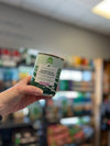Hand holding a can of Open Farm Homestead Turkey Pâté, highlighting the product's label and ethical sourcing promise.