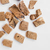 Close-up view of Green Juju Bison Liver Trainers Dog Treats, showing their size and texture.