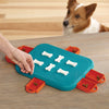 A pet parent placing treats inside the Dog Casino puzzle toy, showing how to set up the challenge for their pup.