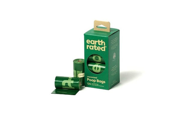 Earth Rated poop bags box with rolls beside it, showing the leak-proof, extra-strong, eco-friendly design.