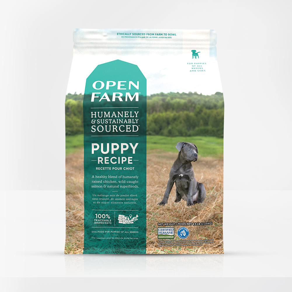 A clear image showcasing the front label of Open Farm Grain Free Puppy Dog Food, emphasizing its key ingredients and grain-free formula.