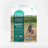 A clear image showcasing the front label of Open Farm Grain Free Puppy Dog Food, emphasizing its key ingredients and grain-free formula.