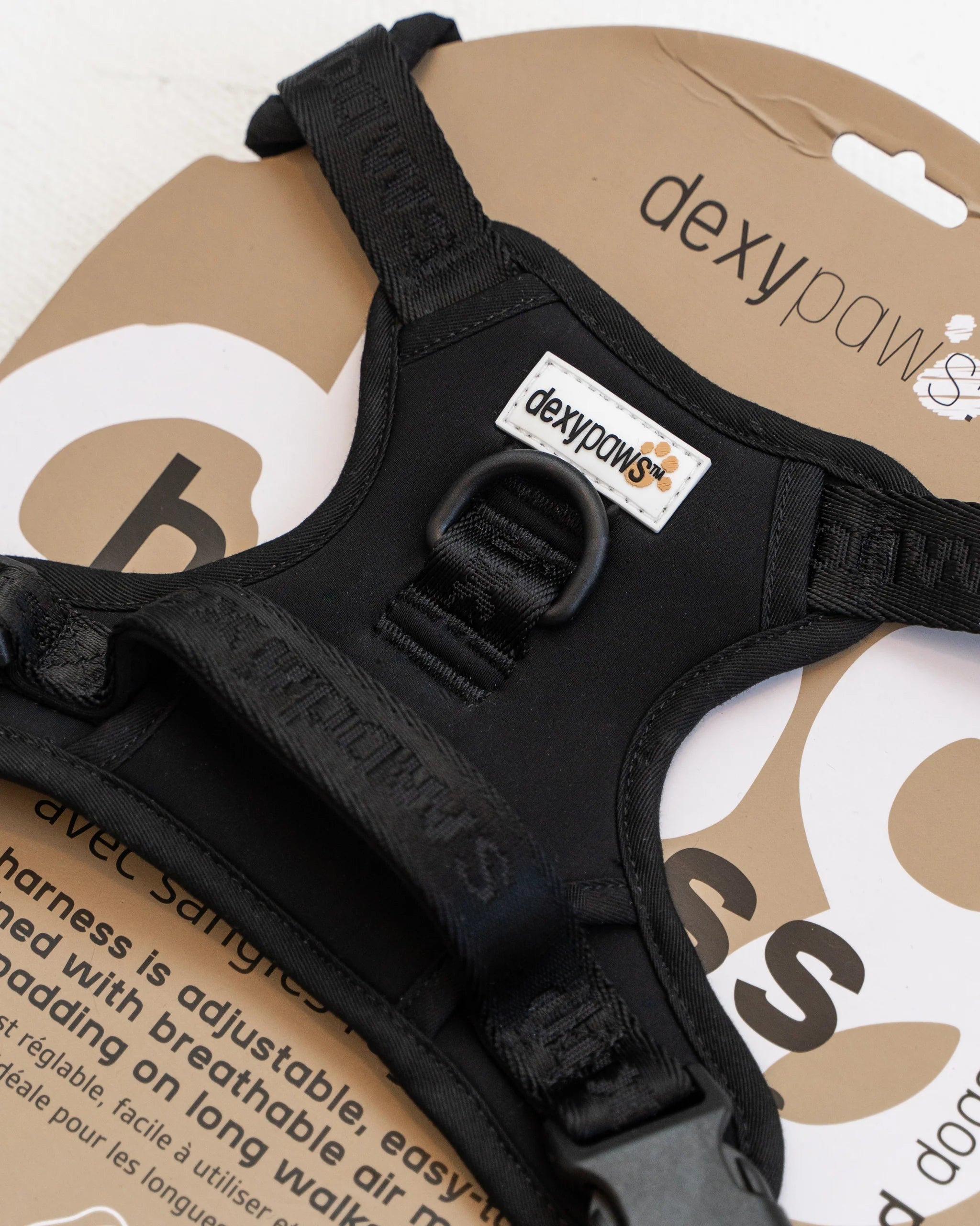 Close-up of the DexyPaws Living My Best Life No Pull Dog Harness inside packaging highlighting premium construction, adjustable security straps, reflective details, breathable air mesh, and durable hardware.