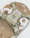 Close-up of the DexyPaws Sage Green dog harness inside packaging highlighting premium hardware, breathable air mesh lining, reflective safety details, adjustable webbing, and durable no-pull construction.