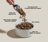 Grain-free puppy food pouring into bowl with arrows highlighting benefits like brain development, muscle growth, healthy digestion, omega fatty acids, and raw nutrition boost