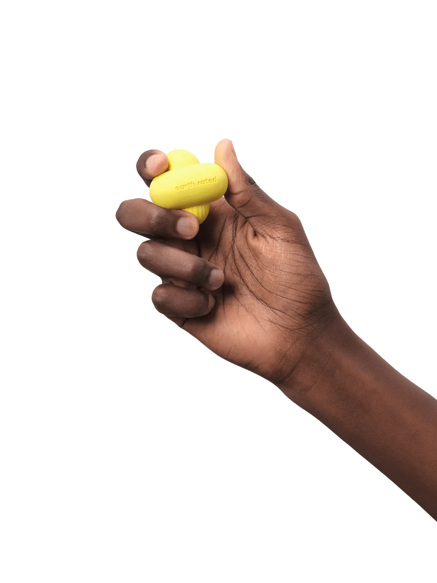 Person holding the small-sized Earth Rated Fetch Toy, demonstrating its lightweight and easy-to-hold design for both dogs and owners.