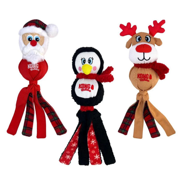 Kong Holiday Wubba toys featuring Christmas-themed characters (reindeer, Santa, penguin) with soft plush, long tails for tugging, and a festive plaid design for interactive play and cozy snuggles.