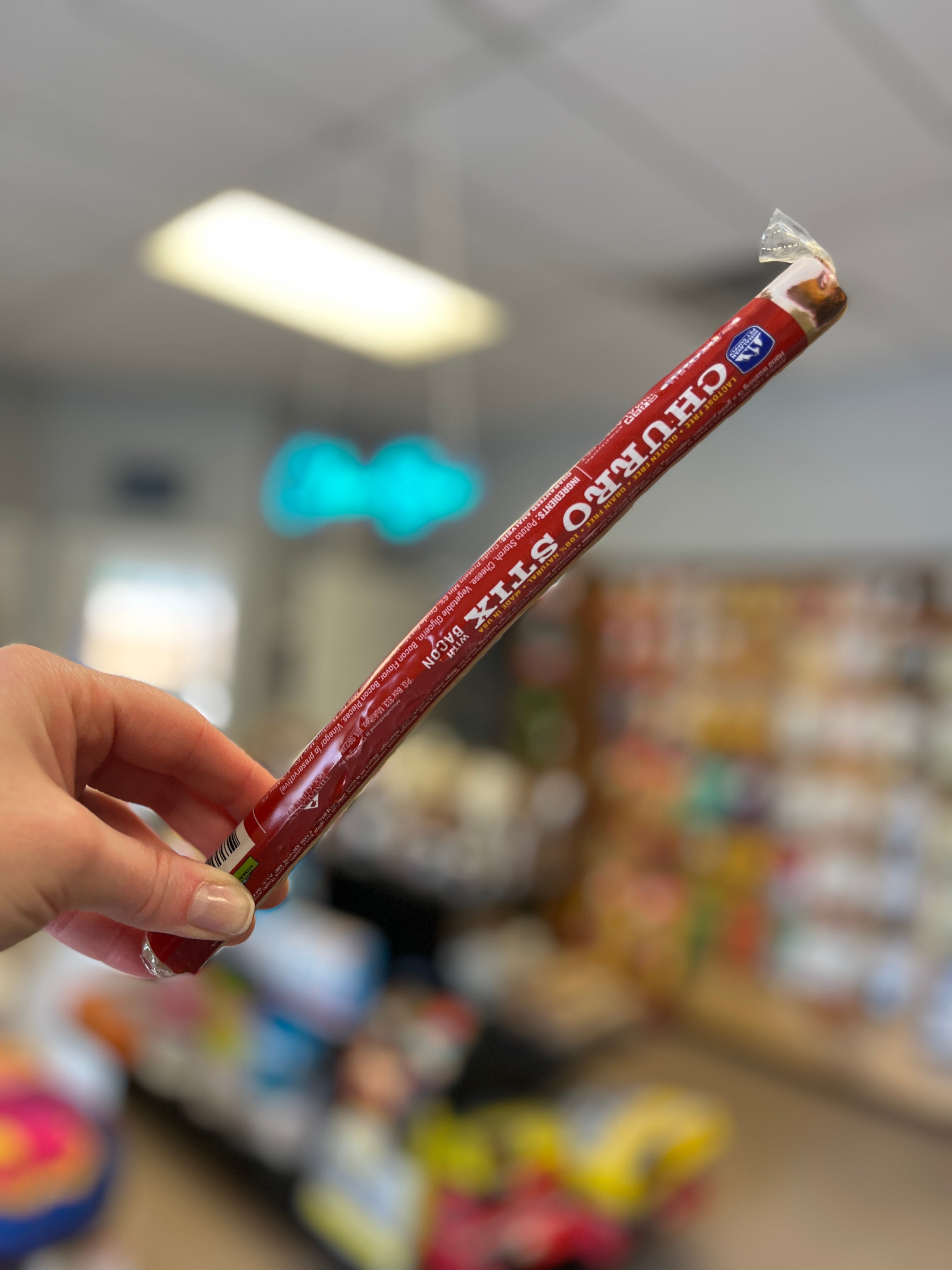 Himalayan Dog Chew Churro Stix in Bacon flavour showcasing its 10-inch size, made with real bacon, and promoting oral health.