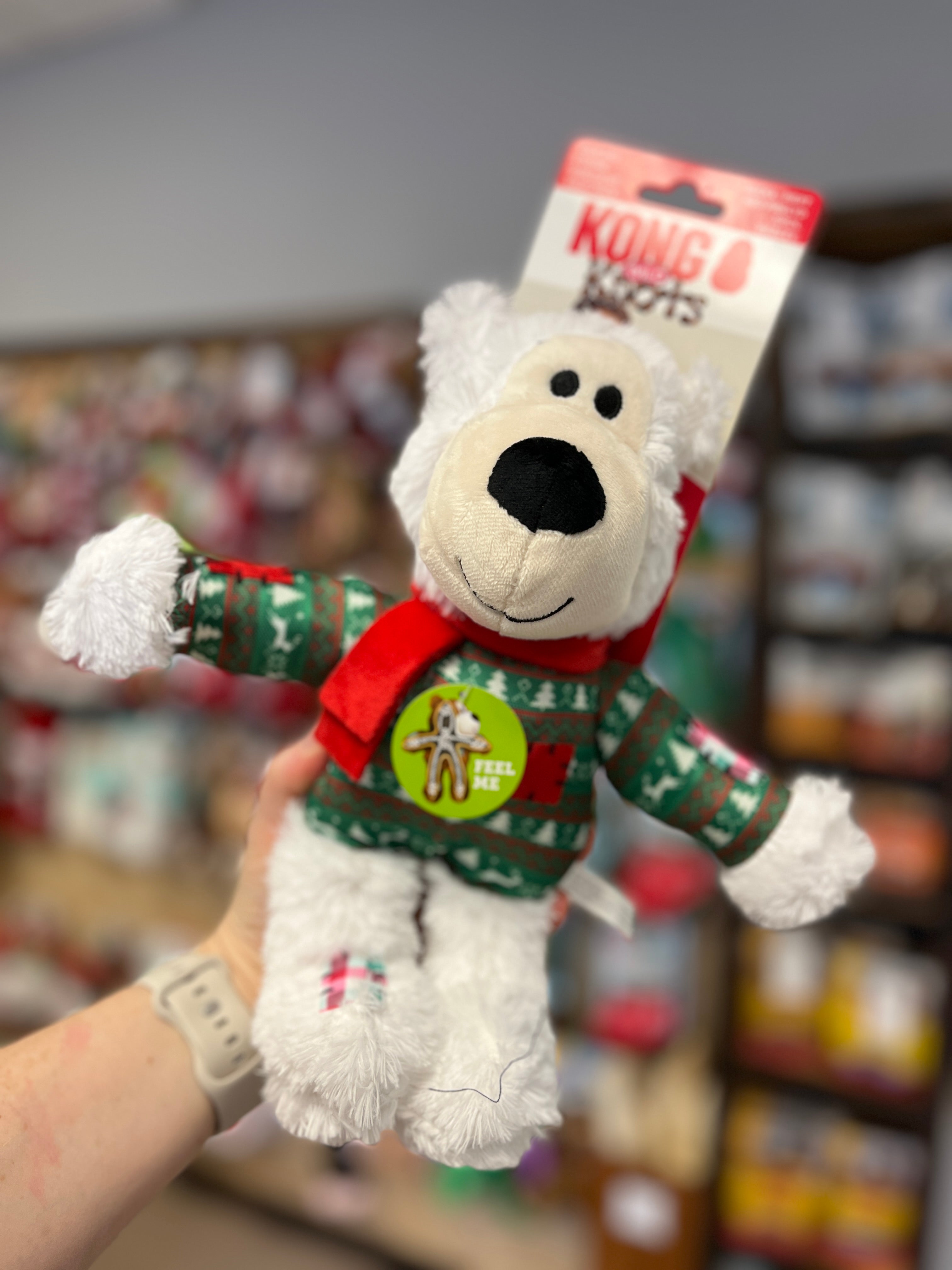 Kong Holiday Wild Knots Bear in White, large size, adorned with winter sweater and scarf, equipped with durable knotted rope and squeaker for fun and snuggles.