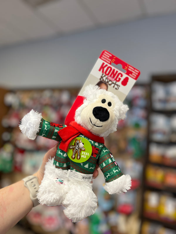 Kong Holiday Wild Knots Bear in White, small size, with cozy sweater and scarf, featuring an internal knotted rope and squeaker for interactive play.