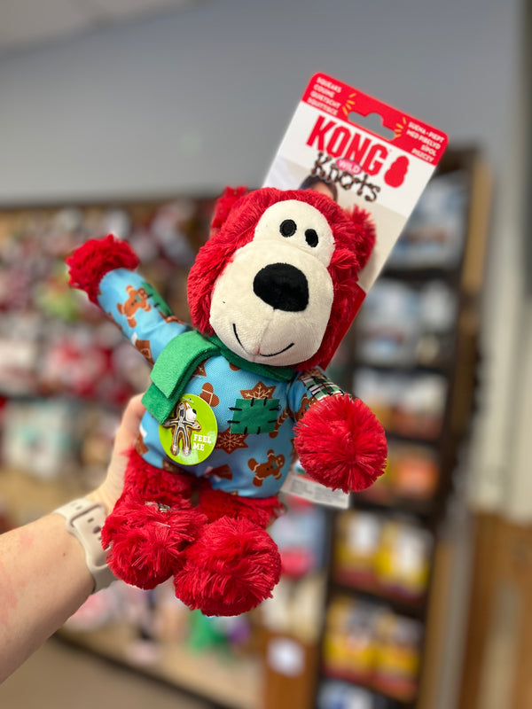 Kong Holiday Wild Knots Bear Red, large size, dressed in festive red sweater and scarf, with durable knotted rope inside and squeaker for exciting play and snuggles.