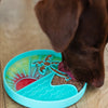 Dog enjoying frozen treats from the textured lick bowl, showing calming enrichment, slower eating to support digestion, and secure non-slip suction that prevents sliding during use.