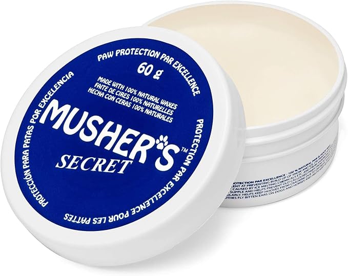 Close-up image of Musher’s Secret 60g balm container, highlighting the all-natural formula that protects paws from hot pavement, icy sidewalks, and rough terrain while keeping pads soft and moisturized.