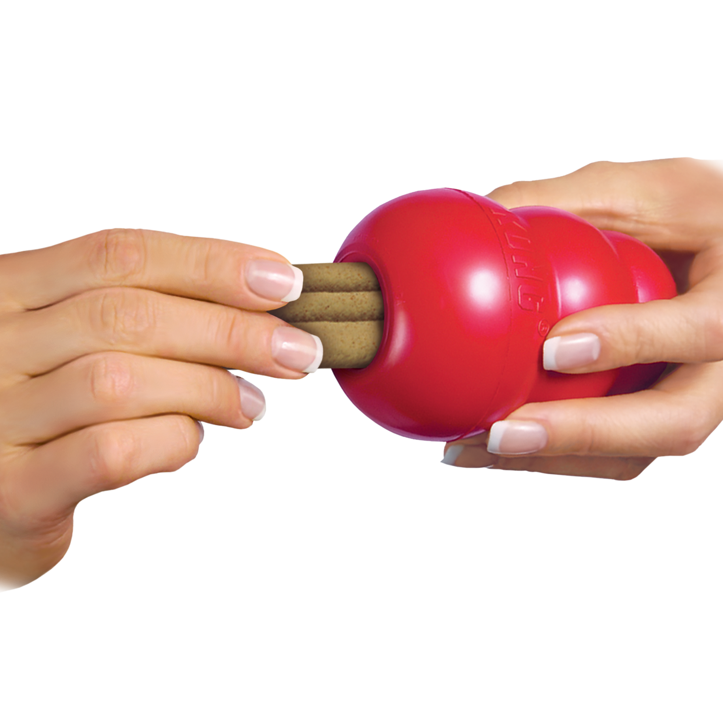 Image of a hand placing a KONG Ziggie into a KONG Classic toy, demonstrating how the chew can be used to enrich playtime while promoting oral hygiene.