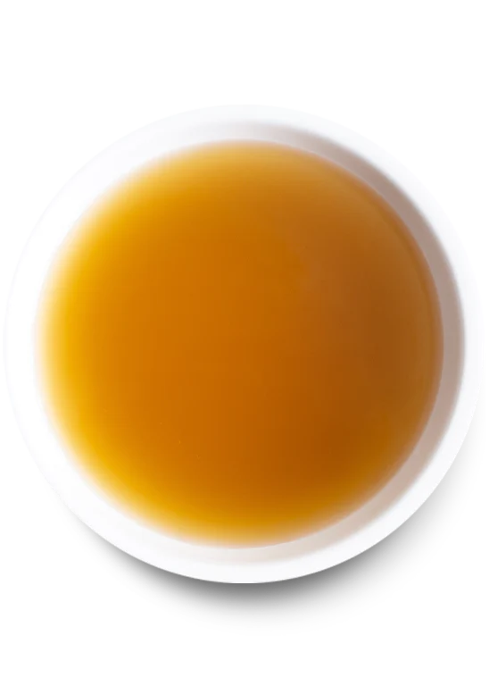 Detailed image of the rich, golden Open Farm Chicken Bone Broth in a bowl, showcasing its texture and quality.